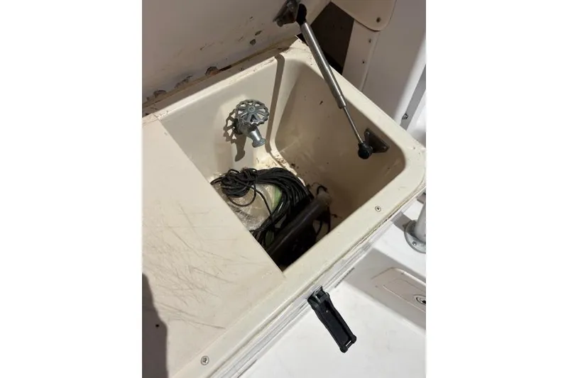Slide: The Image of Storage compartment on a 2003 Grady-White Marlin 300 boat with utility items inside. - 32