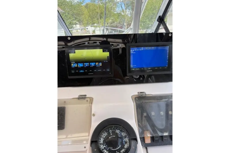 Slide: The Image of Dashboard of a 2003 Grady-White Marlin 300 boat with navigation screens. - 34