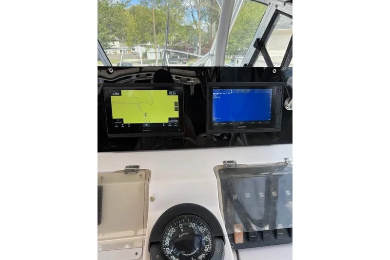 Slide: The Image of Dashboard of a 2003 Grady-White Marlin 300 boat with navigation screens. - 35