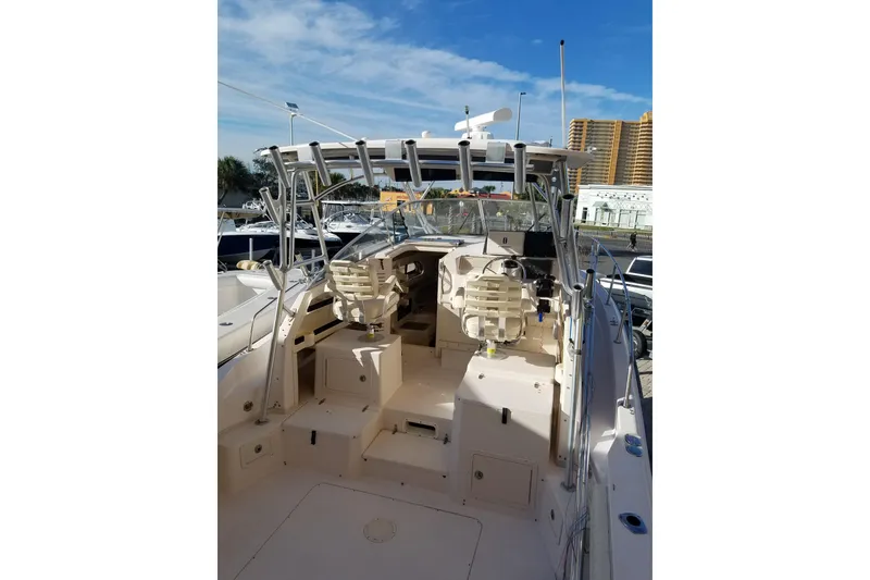 Slide: The Image of 2003 Grady-White Marlin 300 boat interior with helm, seating, and clear sky background. - 4