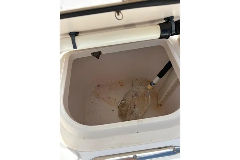 Slide: The Image of Open storage compartment on 2003 Grady-White Marlin 300 boat with net inside. - 41