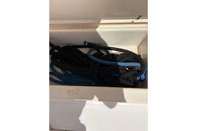 Slide: The Image of Coiled ropes in storage compartment of 2003 Grady-White Marlin 300 boat. - 43