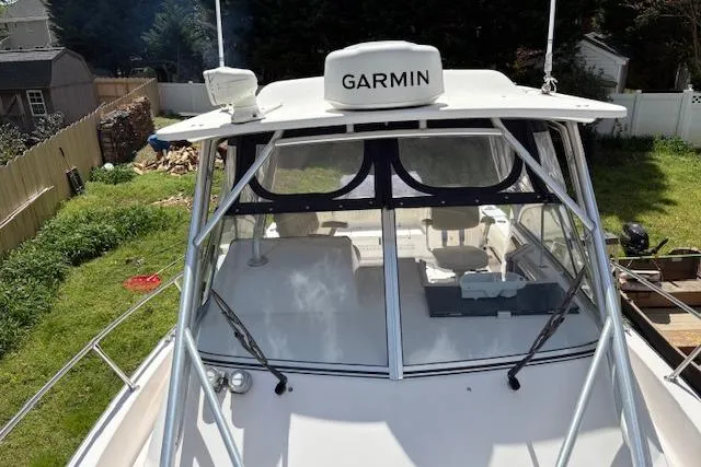 Slide: The Image of 2003 Grady-White Marlin 300 boat with Garmin equipment, docked in a grassy yard. - 48
