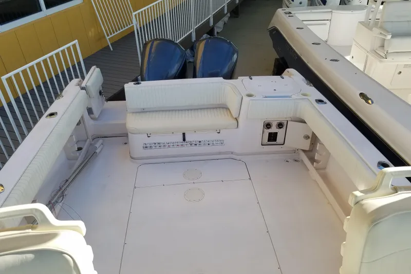 Slide: The Image of 2003 Grady-White Marlin 300 boat deck with seating and twin engines. - 5