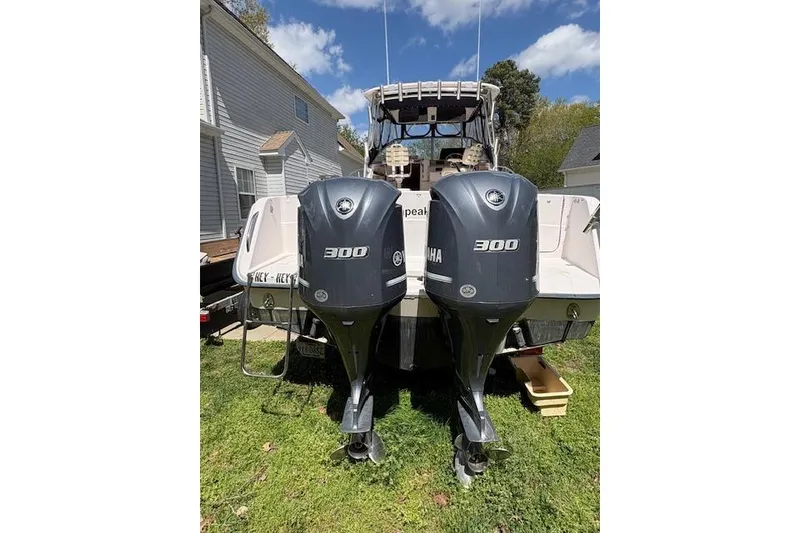 Slide: The Image of 2003 Grady-White Marlin 300 boat with dual Yamaha 300 engines, parked outdoors. - 55