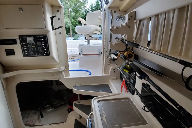Slide: The Image of Interior of 2003 Grady-White Marlin 300 boat with fishing rods and control panel. - 8