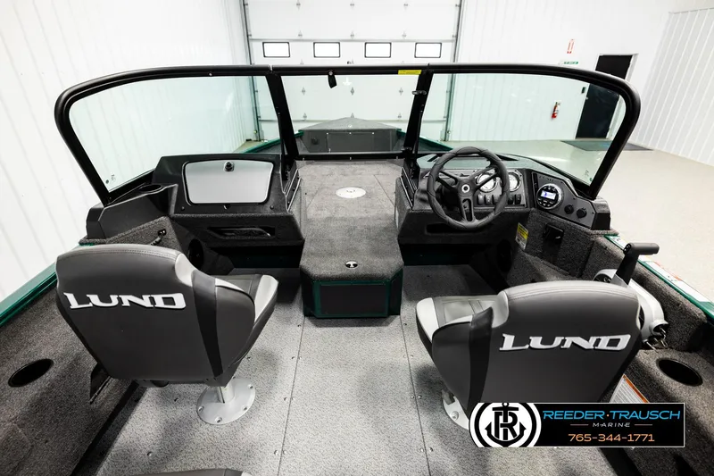 Slide: The Image of 2026 Lund 1775 Adventure Sport boat interior with steering console and seating. - 13