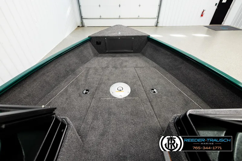 Slide: The Image of 2026 Lund 1775 Adventure Sport boat interior with carpeted deck and storage compartments. - 14