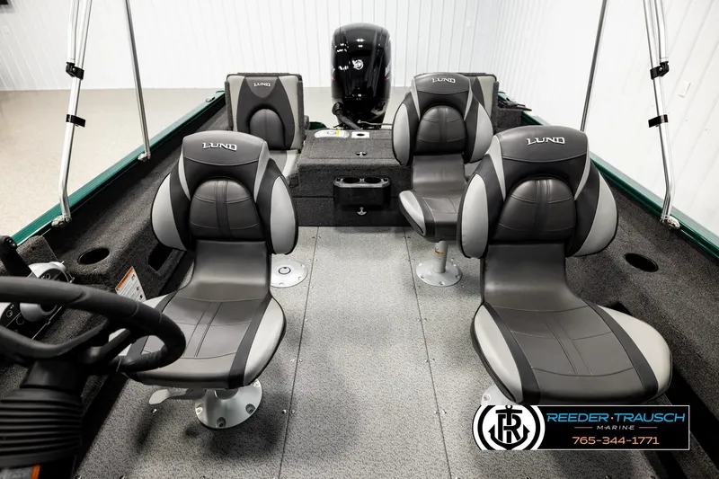 Slide: The Image of 2026 Lund 1775 Adventure Sport boat interior with four gray seats and steering wheel. - 16