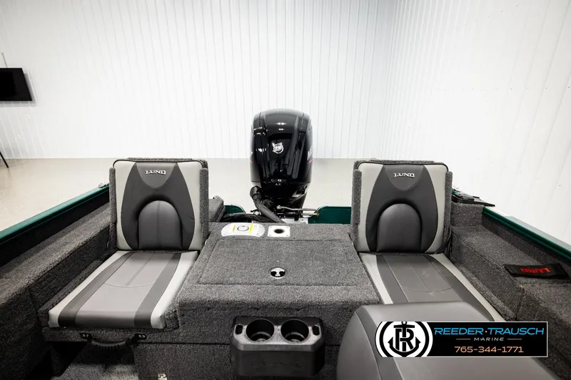 Slide: The Image of 2026 Lund 1775 Adventure Sport boat interior with dual seats and motor, Reeder-Trausch Marine branding. - 17
