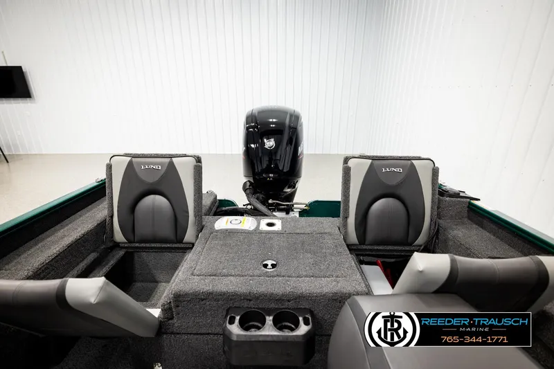 Slide: The Image of 2026 Lund 1775 Adventure Sport boat interior with seating and motor, displayed in showroom. - 18