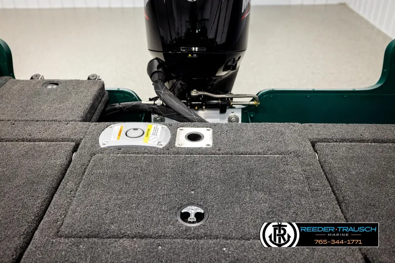 Slide: The Image of 2026 Lund 1775 Adventure Sport boat interior with motor and carpeted deck. - 20