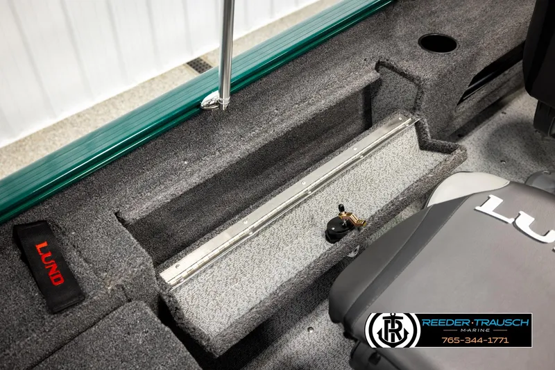 Slide: The Image of 2026 Lund 1775 Adventure Sport boat interior with carpeted flooring and branded seating. - 23