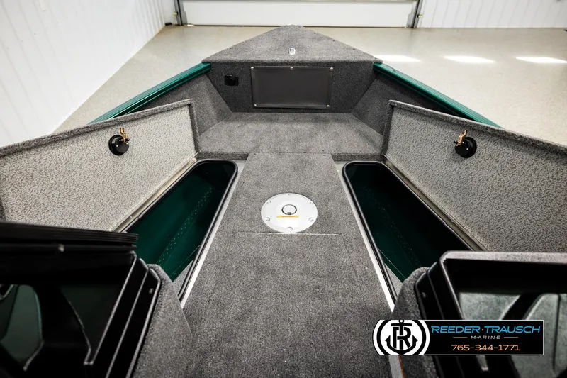 Slide: The Image of 2026 Lund 1775 Adventure Sport boat interior with storage compartments, gray carpeting, and sleek design. - 25