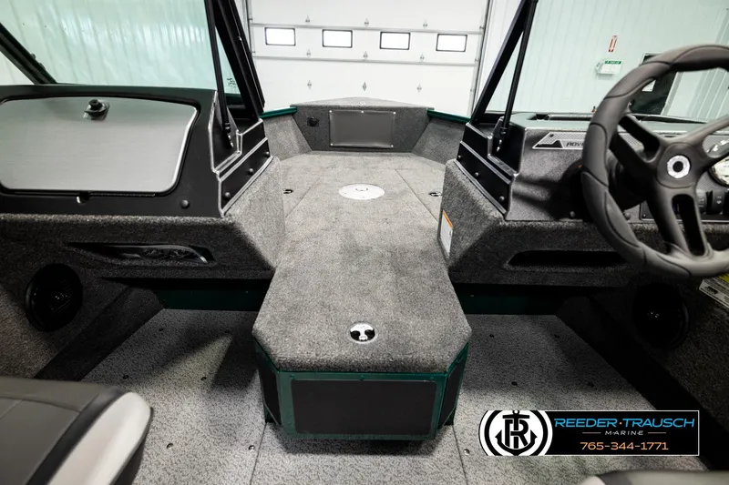 Slide: The Image of 2026 Lund 1775 Adventure Sport boat interior with steering wheel and carpeted deck. - 26