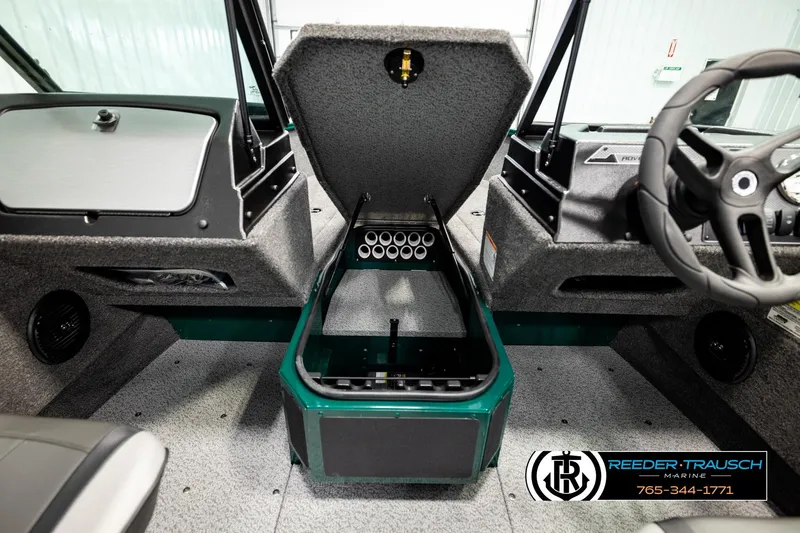 Slide: The Image of 2026 Lund 1775 Adventure Sport boat interior with open storage compartment and steering wheel. - 27