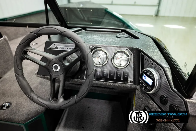 Slide: The Image of 2026 Lund 1775 Adventure Sport boat dashboard with steering wheel and gauges. - 28