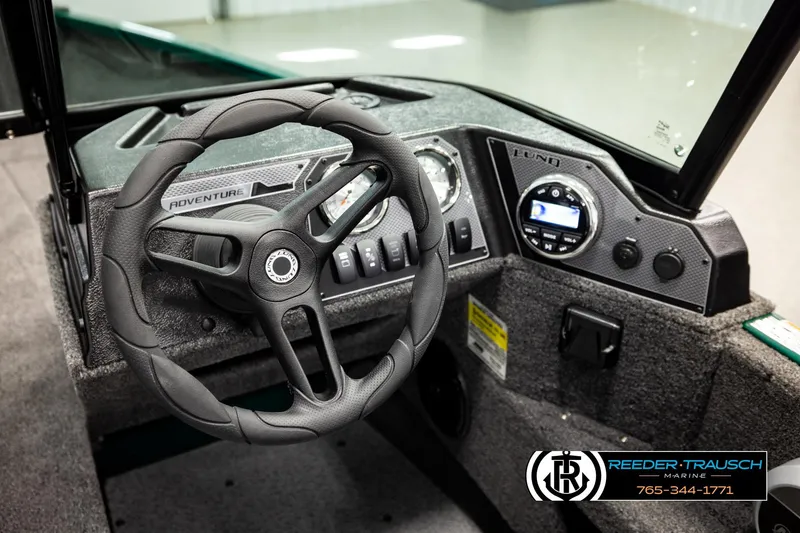 Slide: The Image of 2026 Lund 1775 Adventure Sport boat dashboard with steering wheel and control panel. - 29