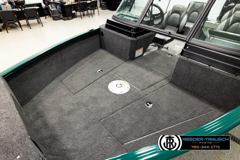 Slide: The Image of 2026 Lund 1775 Adventure Sport boat interior with carpeted deck and seating area. - 9