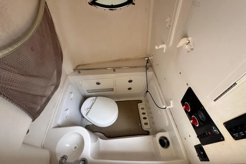 Slide: The Image of Interior of 2015 Sailfish 320 CC featuring toilet and sink. - 15