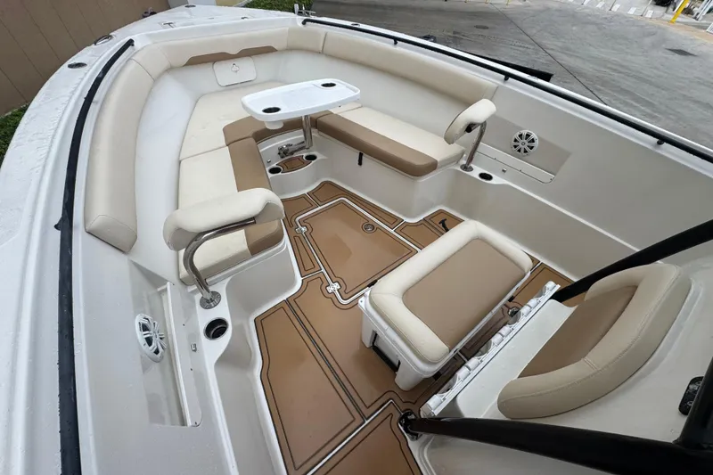 Slide: The Image of 2015 Sailfish 320 CC boat interior with beige seating and table. - 18