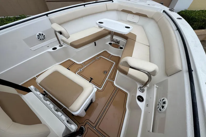 Slide: The Image of 2015 Sailfish 320 CC boat interior with beige seating and a small table. - 19