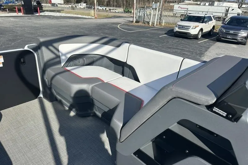 Slide: The Image of 2024 Manitou Cruise 22 Bench Tritoon interior with modern seating design. - 12