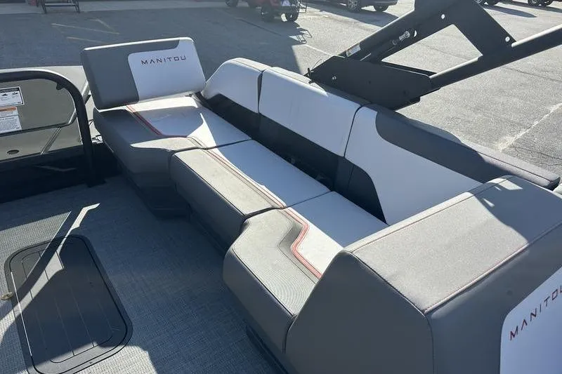 Slide: The Image of 2024 Manitou Cruise 22 Bench Tritoon interior with modern seating design. - 13
