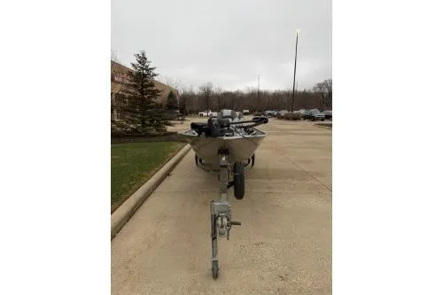 Slide: The Image of 2007 Tracker Pro Guide V-16 T boat on trailer in parking lot. - 3