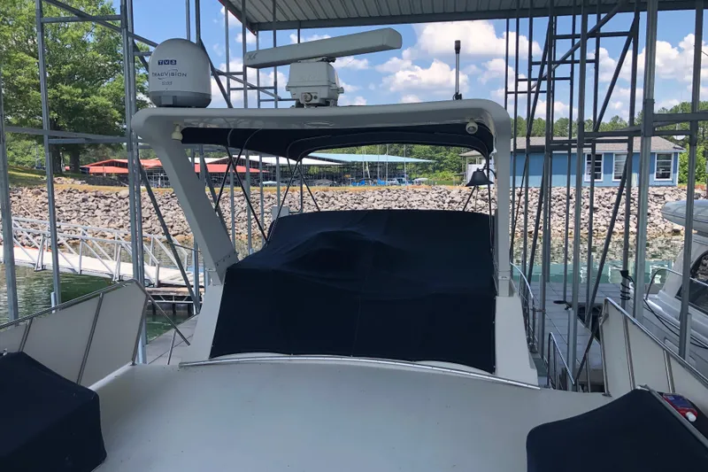 Slide: The Image of 1989 Bluewater Yachts 55' Coastal Cruiser docked under a covered marina. - 30