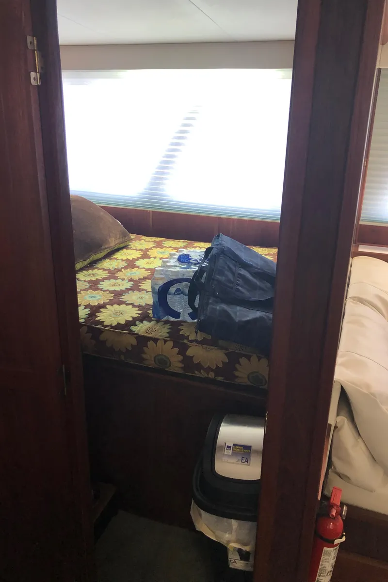 Slide: The Image of 1989 Bluewater Yachts 55' Coastal Cruiser bedroom with floral bedspread and luggage. - 46