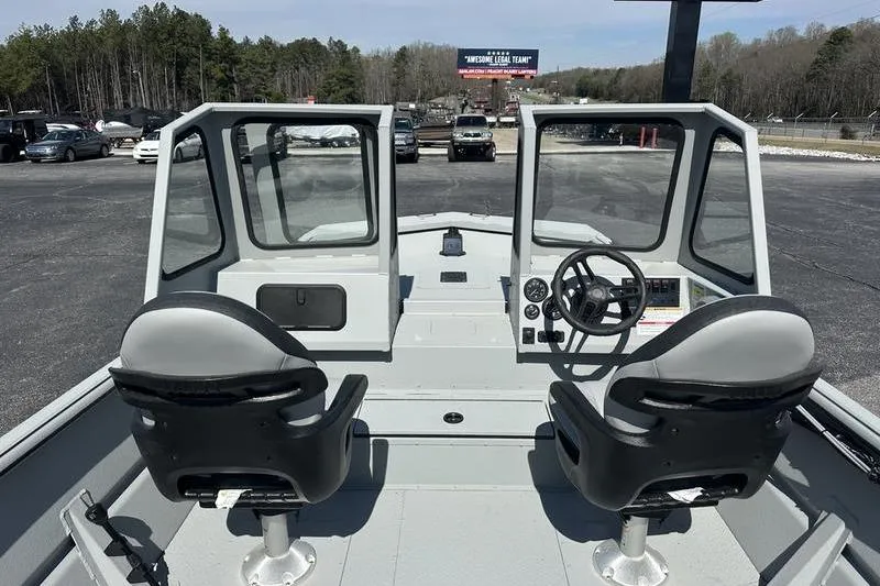Slide: The Image of 2026 SeaArk 2272 MVT boat interior with dual seats and steering console. - 4
