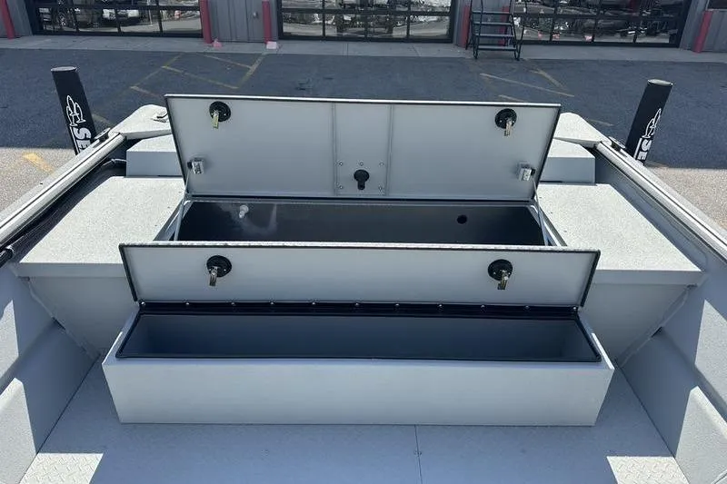 Slide: The Image of 2026 SeaArk 2272 MVT boat storage compartments open, showcasing interior space. - 7