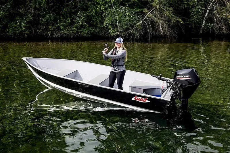 Slide: The Image of Manufacturer Provided Image: 2026 Lund WC-14 boat with Mercury motor on a serene lake. - 10