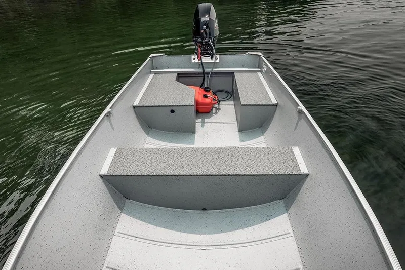 Slide: The Image of Manufacturer Provided Image: 2026 Lund WC-14 boat interior with motor, on calm water. - 13