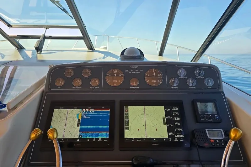 Slide: The Image of Helm of 1995 Tiara Yachts 3500 Express with navigation screens and gauges. - 11