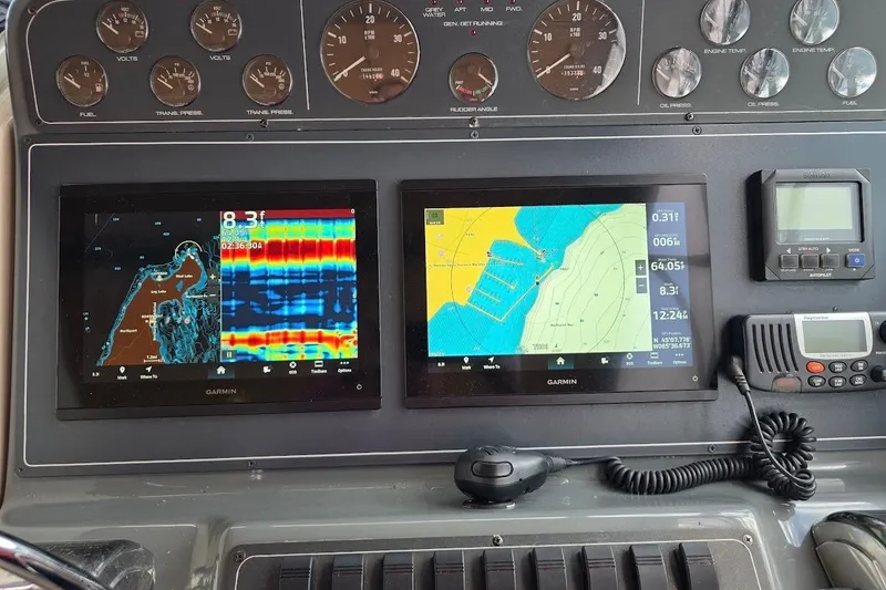 Slide: The Image of Dashboard of a 1995 Tiara Yachts 3500 Express with Garmin navigation displays. - 12