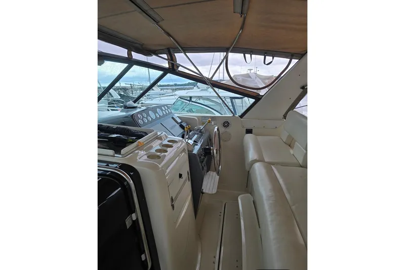 Slide: The Image of 1995 Tiara Yachts 3500 Express interior with helm, seating, and dashboard view. - 13