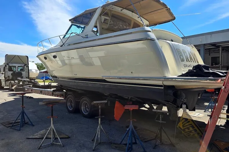 Slide: The Image of 1995 Tiara Yachts 3500 Express on trailer, undergoing maintenance at a boatyard. - 2