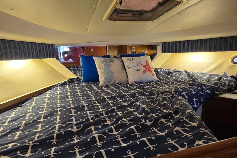 Slide: The Image of Cozy cabin interior of 1995 Tiara Yachts 3500 Express with nautical-themed bedding. - 20