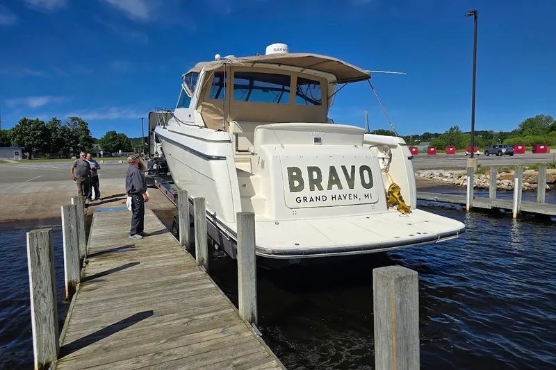 Slide: The Image of 1995 Tiara Yachts 3500 Express docked at Grand Haven, MI, with people nearby. - 4
