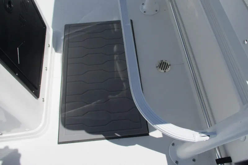 Slide: The Image of Interior view of 2026 Avid 19 FSX boat, featuring deck details and railing. - 13