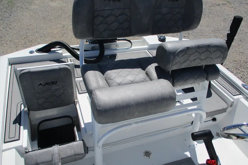 Slide: The Image of 2026 Avid 19 FSX boat interior with gray cushioned seating and steering controls. - 15