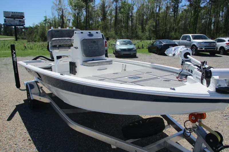 Slide: The Image of 2026 Avid 19 FSX boat on trailer, parked outdoors with trees and vehicles in background. - 4