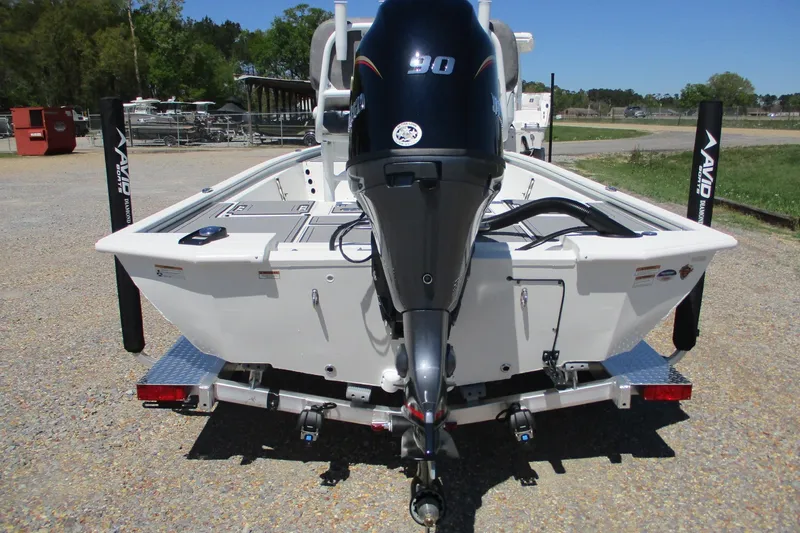 Slide: The Image of 2026 Avid 19 FSX boat with powerful outboard motor, parked on a trailer. - 6
