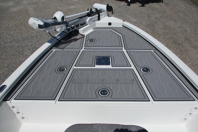 Slide: The Image of 2026 Avid 19 FSX boat deck with gray non-slip surface and mounted trolling motor. - 8