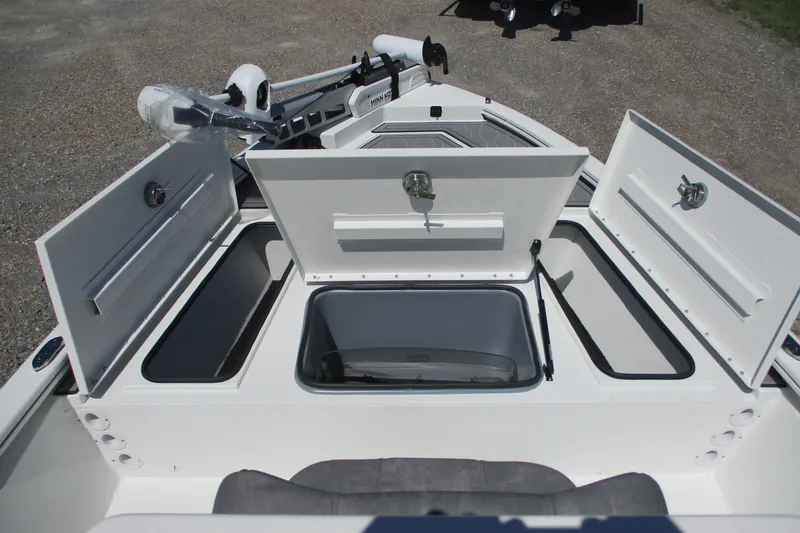 Slide: The Image of 2026 Avid 19 FSX boat with open storage compartments and trolling motor. - 9