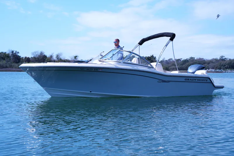 Slide: The Image of 2019 Grady-White Freedom 215 boat cruising on calm blue water. - 10