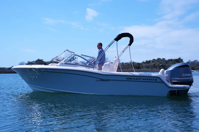 Slide: The Image of 2019 Grady-White Freedom 215 boat on calm water with Yamaha outboard motor. - 13