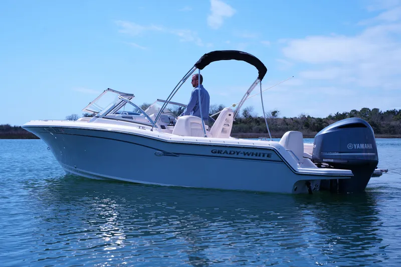 Slide: The Image of 2019 Grady-White Freedom 215 boat on calm water with Yamaha engine. - 14